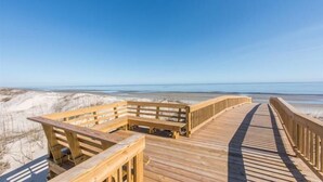 A wooden boardwalk leading to a beach with clear skies. - Ocean Oaks 19 - gorgeous home only a short walk to pool and beach (Jekyll Island)