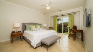 A bedroom with a bed, bedside tables, a desk, and a chair. - Los Suenos Resort Del Mar 4N (Jacó)