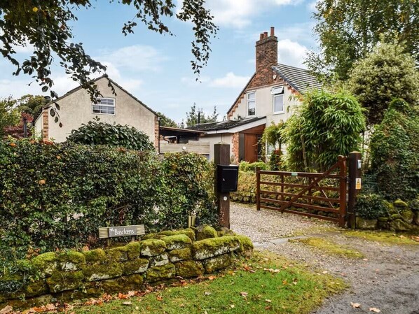 A residential property with a brick house, a wooden gate, and a sign reading "Brackens." - Luxury Private Accommodation & Hot Tub Set Within Gardens With Summer House (Manley)