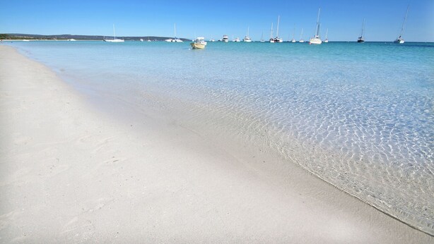 A beach with clear shallow waters and several sailboats anchored in the distance. - Fantastic Beach House on Quindalup Strip (Quindalup)