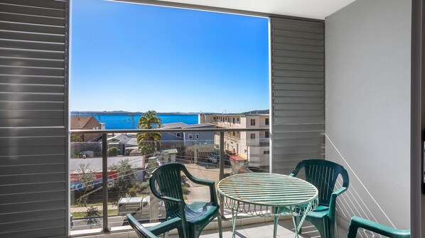 Enjoy breathtaking views of the sea and surrounding residential area from this balcony.