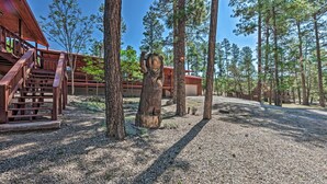 A wooden cabin with a staircase, surrounded by trees and gravel. - Wooded Ruidoso Hideaway w/ Deck: Ski, Hike & Golf! (Ruidoso)