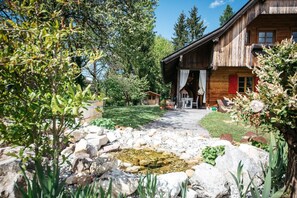 Guests can enjoy a peaceful retreat in this cabin surrounded by lush gardens and a serene atmosphere.