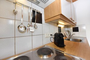 Enjoy cooking in this well-equipped kitchen with a stainless steel stove top, coffee maker, and sink.