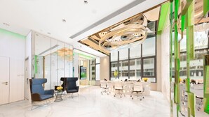 A modern conference room with a large table, chairs, and a unique ceiling design.