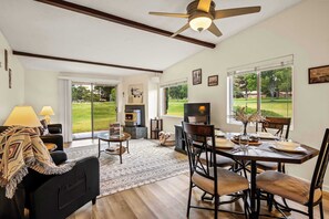 A dining area with a table set for four, a fireplace, and a view of the outdoors. - Cozy, Comfortable on Golf Course! Wild Turkey #11 (Sedona)