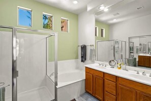 Bathtub, hair dryer, towels, shampoo