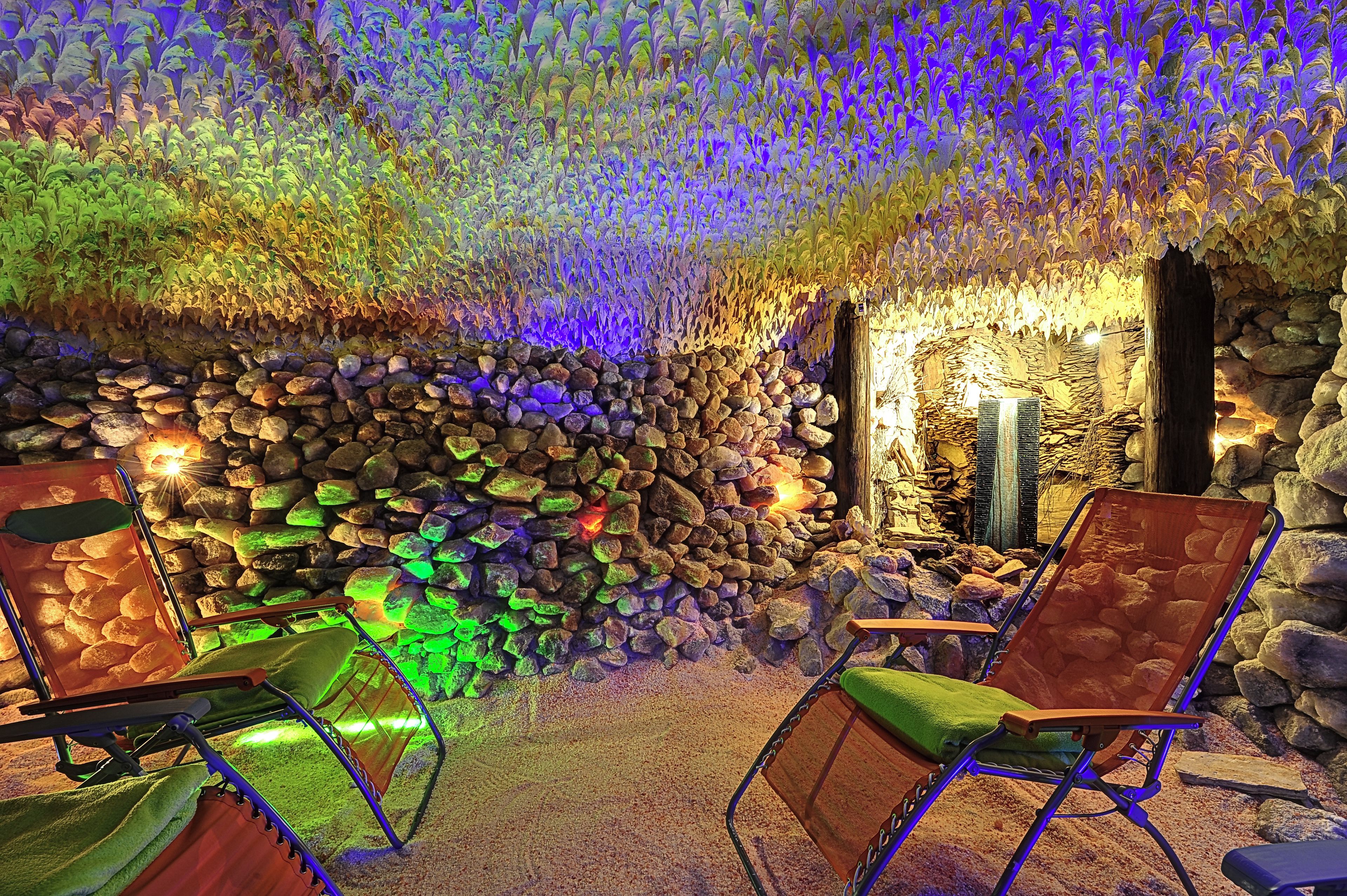 A cave-like interior with seating and a stone wall.