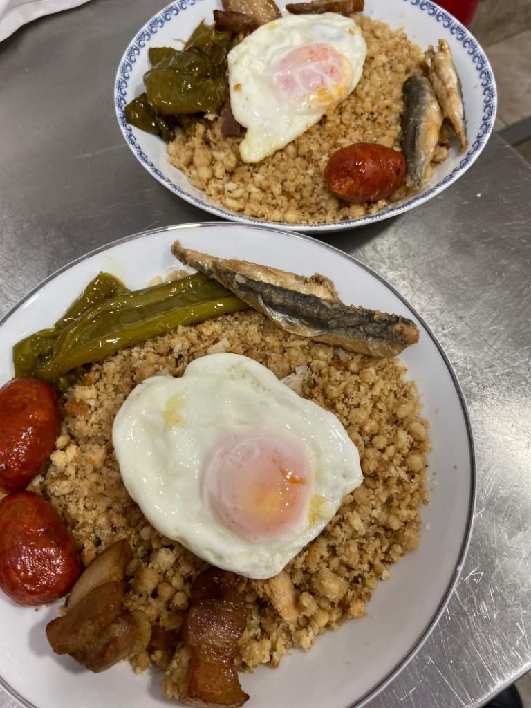 Two plates of food with rice, eggs, and various vegetables.