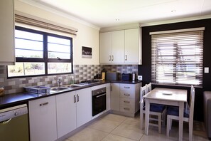 Deluxe Cottage, 1 Bedroom | Private kitchen | Fridge, microwave, oven, stovetop - Mayfair Farm Cottages (Oudtshoorn)