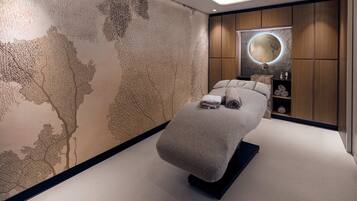 Relax in a serene bedroom with a neatly made bed, round mirror, and shelf.