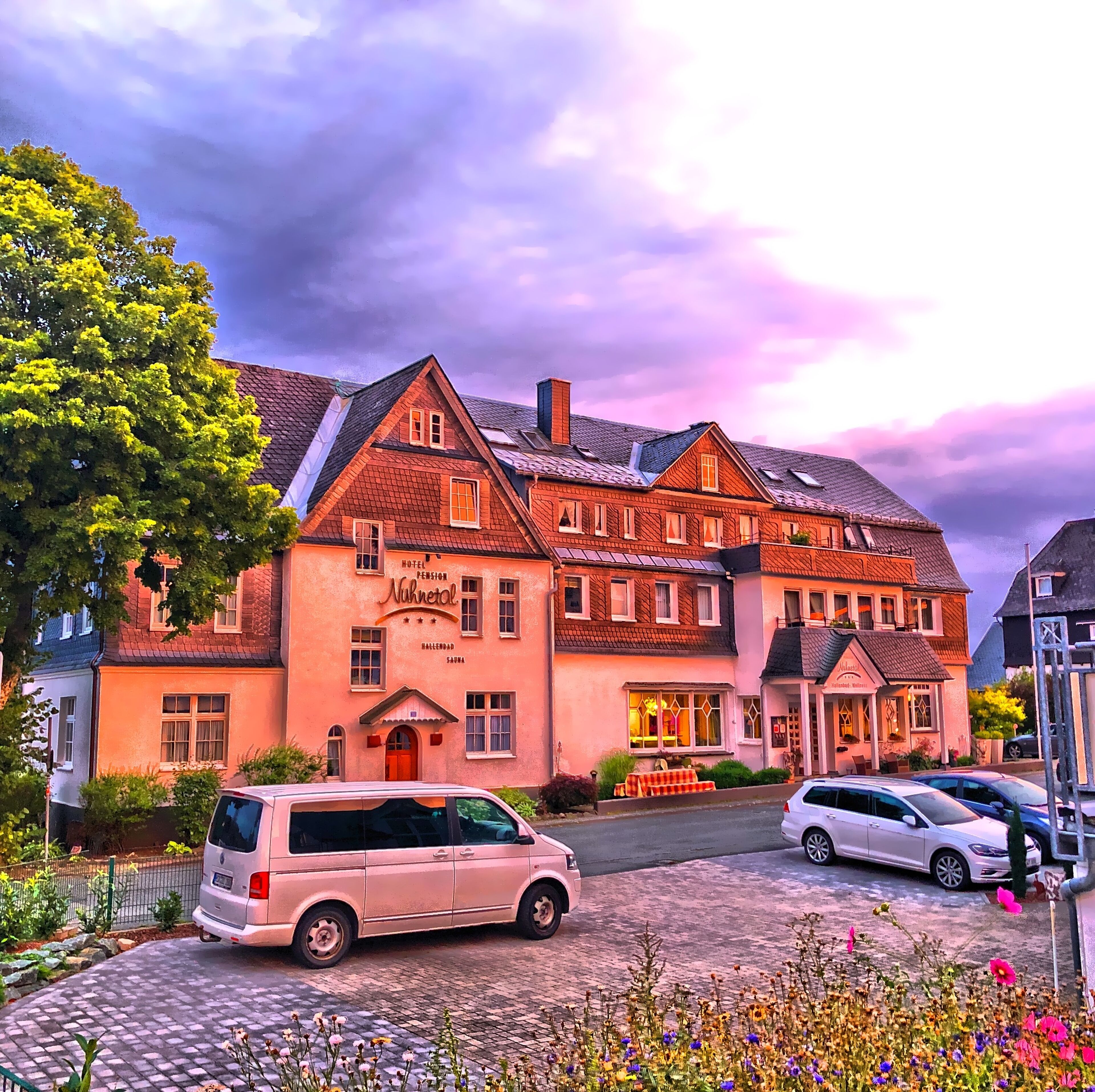 A hotel with a traditional European architectural style, featuring multiple stories and a prominent entrance.