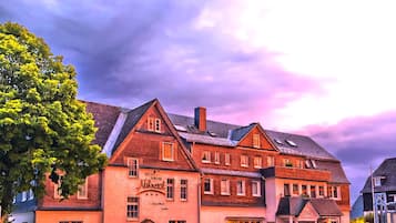 A hotel with a traditional European architectural style, featuring multiple stories and a prominent entrance.