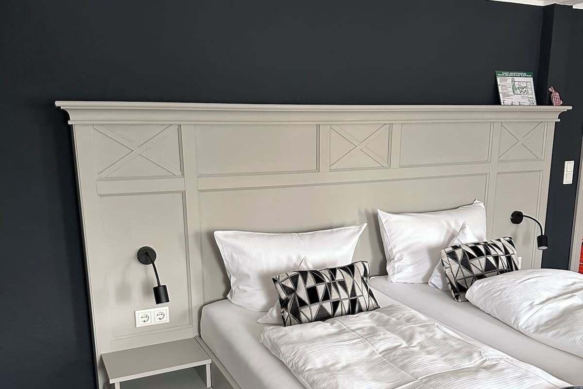 A bedroom with a bed, bedside tables, and a nightstand.