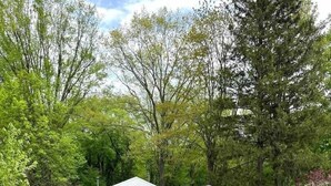 A two-story house with a garage, a driveway, and a well-maintained lawn.