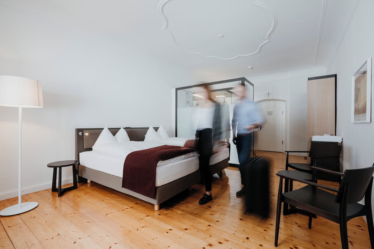 Premium bedding, desk, laptop workspace, blackout drapes