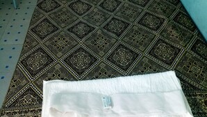 A single bed with a patterned bedspread, a white pillow, and a white blanket. - Jambo Guest House (Gilgil)