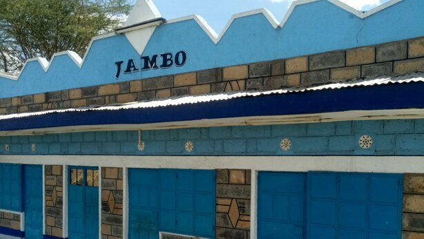 A building with a sign reading "JAMBO". - Jambo Guest House (Gilgil)