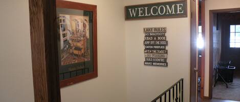 A hallway with a 'WELCOME' sign and a list of activities like 'Go barefoot' and 'Read a book'.
