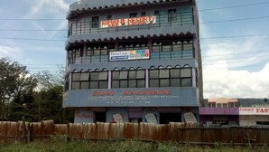 A multi-story building with signage for 'Roman Resort Bar & Lounge' and 'Sidai Hardware'. - Romani Resort (Nakuru)