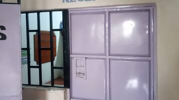 A reception area with a sign above a set of lockers.