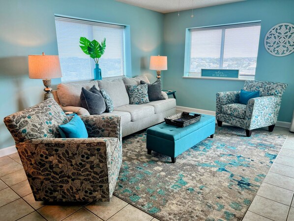A living room with a sofa, two armchairs, a coffee table, and a potted plant. - Blue Water Keyes-Oceanfront- Updated 2/2 -Multiple Pools-Lazy River-Family Fun (North Myrtle Beach)