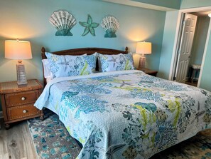 A bedroom with a bed, two nightstands, and decorative wall art. - Blue Water Keyes-Oceanfront- Updated 2/2 -Multiple Pools-Lazy River-Family Fun (North Myrtle Beach)