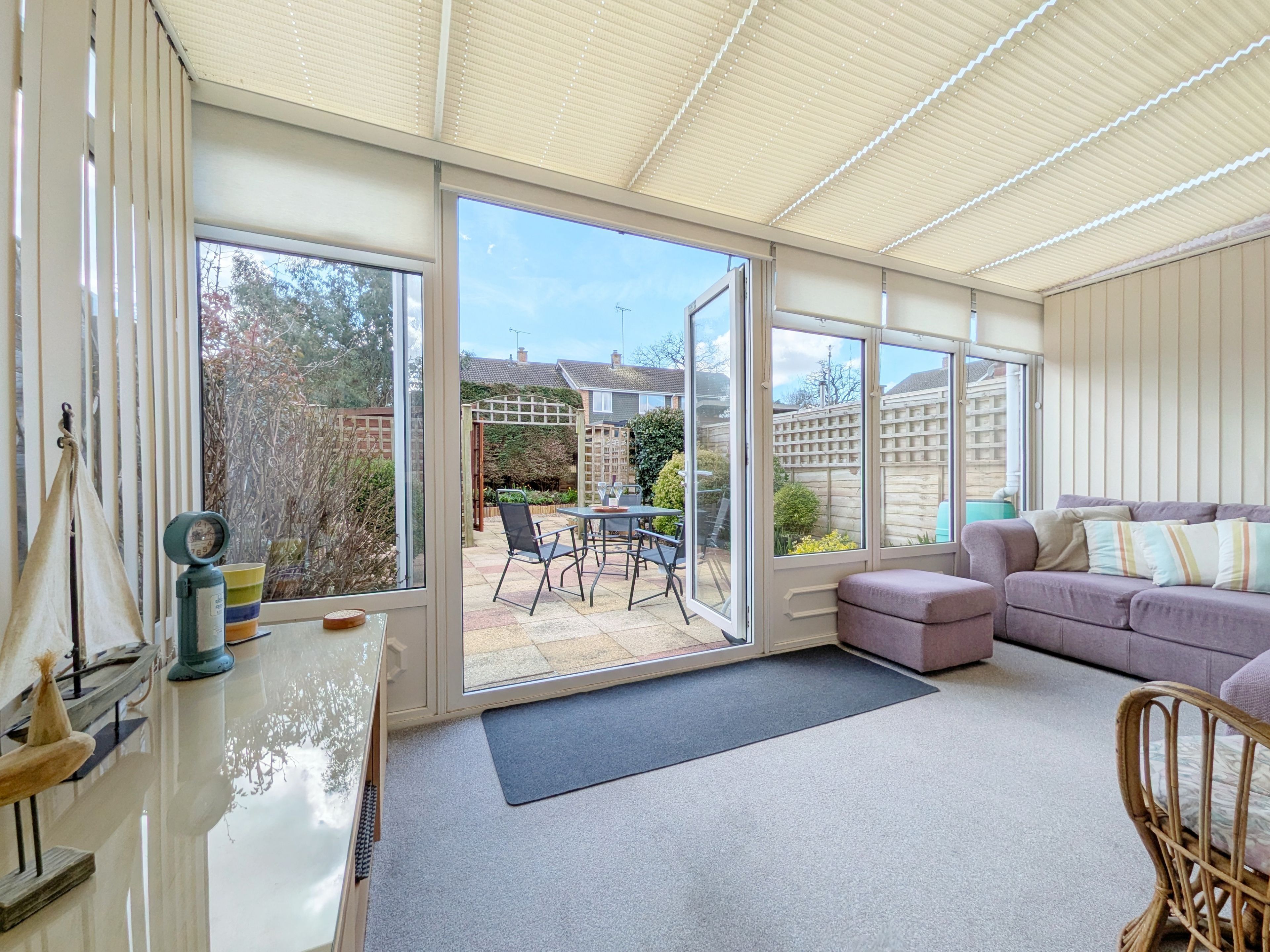 A spacious room with a large sliding glass door leading to an outdoor patio area.