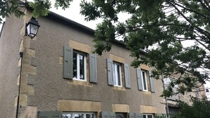 En bygning med mange vinduer, hvoraf nogle har skodder, og en detaljeret facade.