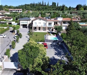 A residential area with houses, a swimming pool, and a driveway.