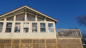 A two-story building with a gabled roof and multiple windows. - Year-Round: Amazing Sunrises, 150ft Shore, Private Boat Launch/Dock, Hot Fishing (Alburg)