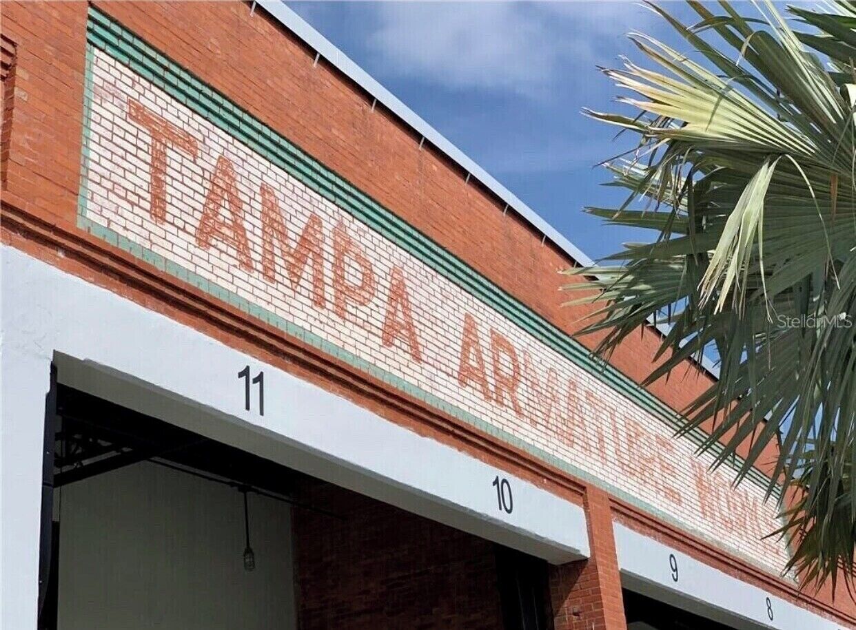A building facade with the words "TAMPA ARCADE" and numbered doors 10, 11, and 8.