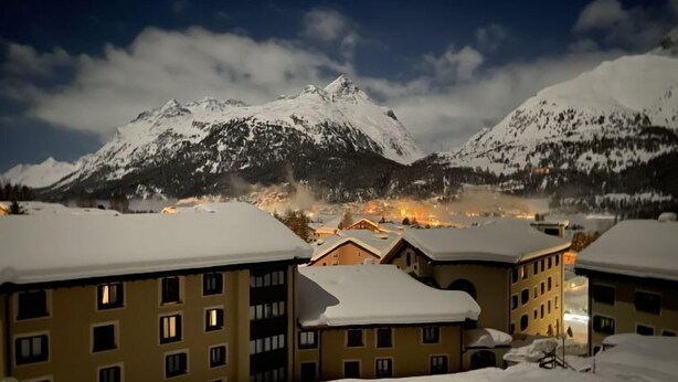 A snow-covered mountain landscape with buildings in the foreground. - Residenza Chesa Margun 78-1 by Interhome (Silvaplana-Surlej)