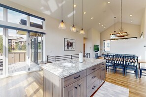 Enjoy cooking in this well-equipped kitchen with a large island, oven, and range hood.
