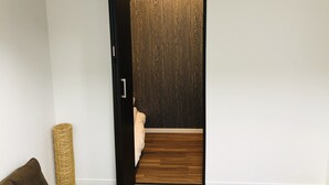 A hallway with a wooden wall and a wooden floor.