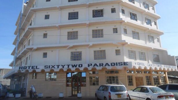 A multi-story hotel named "Hotel SixtyTwo Paradise" with a classic architectural style, featuring a central entrance and multiple windows on each floor. - Sixty Two Paradise Hotel (Nanyuki)