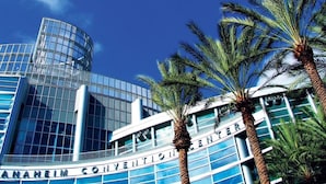 Das Anaheim Convention Center mit moderner Glasfassade und Palmen im Vordergrund.