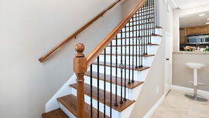 A wooden staircase with black balusters leading to a landing. - Awesome Multi Level - Large Patio - Fast WIFI - Work Desks - Self Check In! (CM-2) (Costa Mesa)