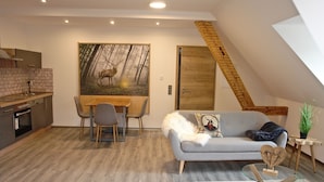 Un loft moderno con comedor, sofá y escalera.