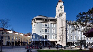 A historic building with a clock tower, a central courtyard, and surrounding shops. - JOIVY Spacious 1-bed Apt nearby Time Out Market &subway (Lisboa)