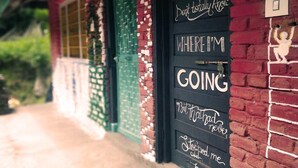 A building with a black door and a sign that reads "Where I'm Going." - The Hostalgic Jibhi - Hostel (Banjar)