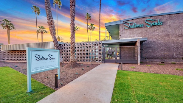 A modern building with a sign reading "Shalimar Sands Apartments" at 6824 E. 4th St., Scottsdale, Arizona. - Pool front Condo, steps from memorable Old Town. (Scottsdale)