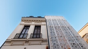 A tall building with a classical facade and a modern, perforated glass facade. - Stil Old Town Boutique Hotel (Bucharest)