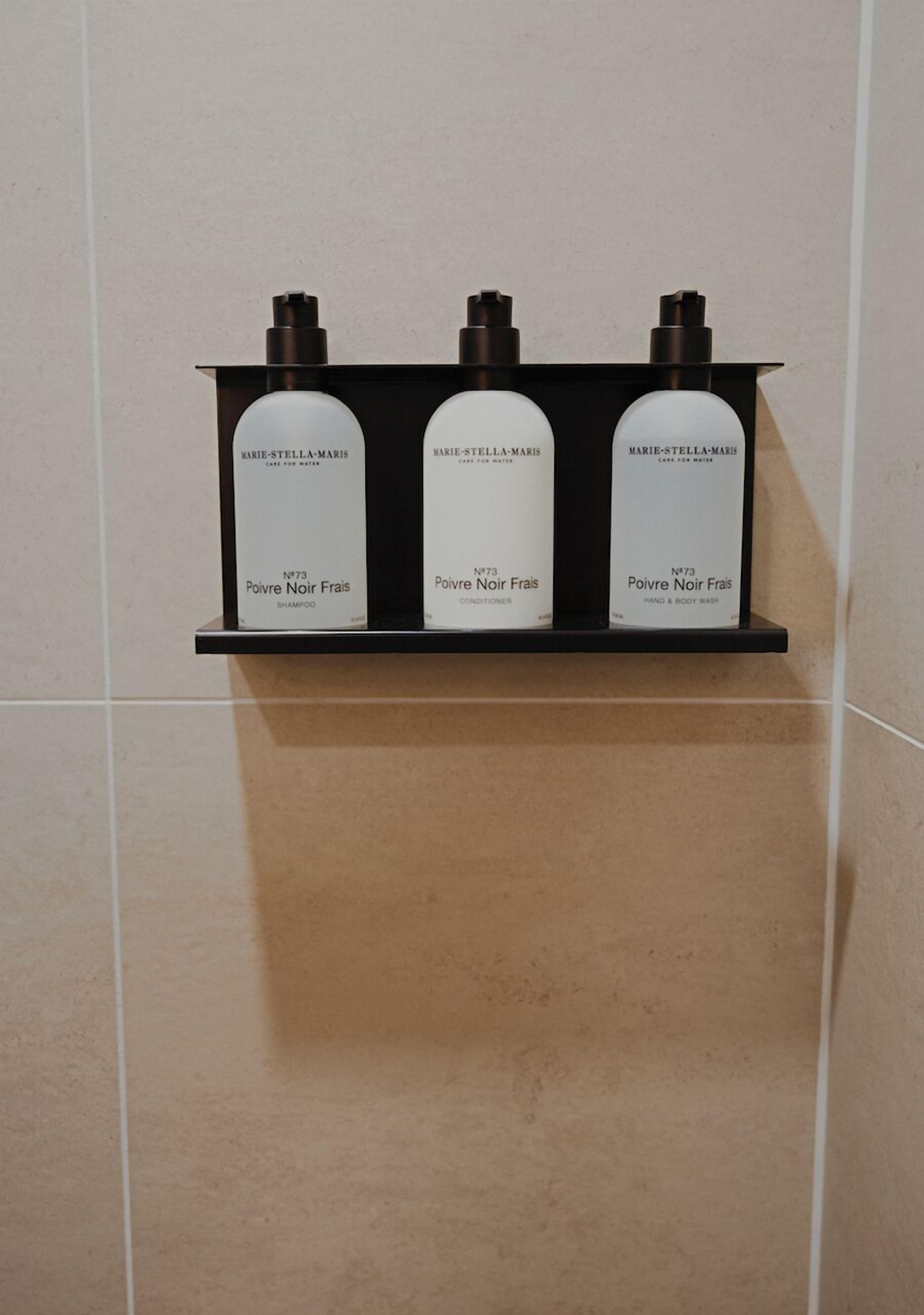 designer toiletries, hair dryer, towels, soap