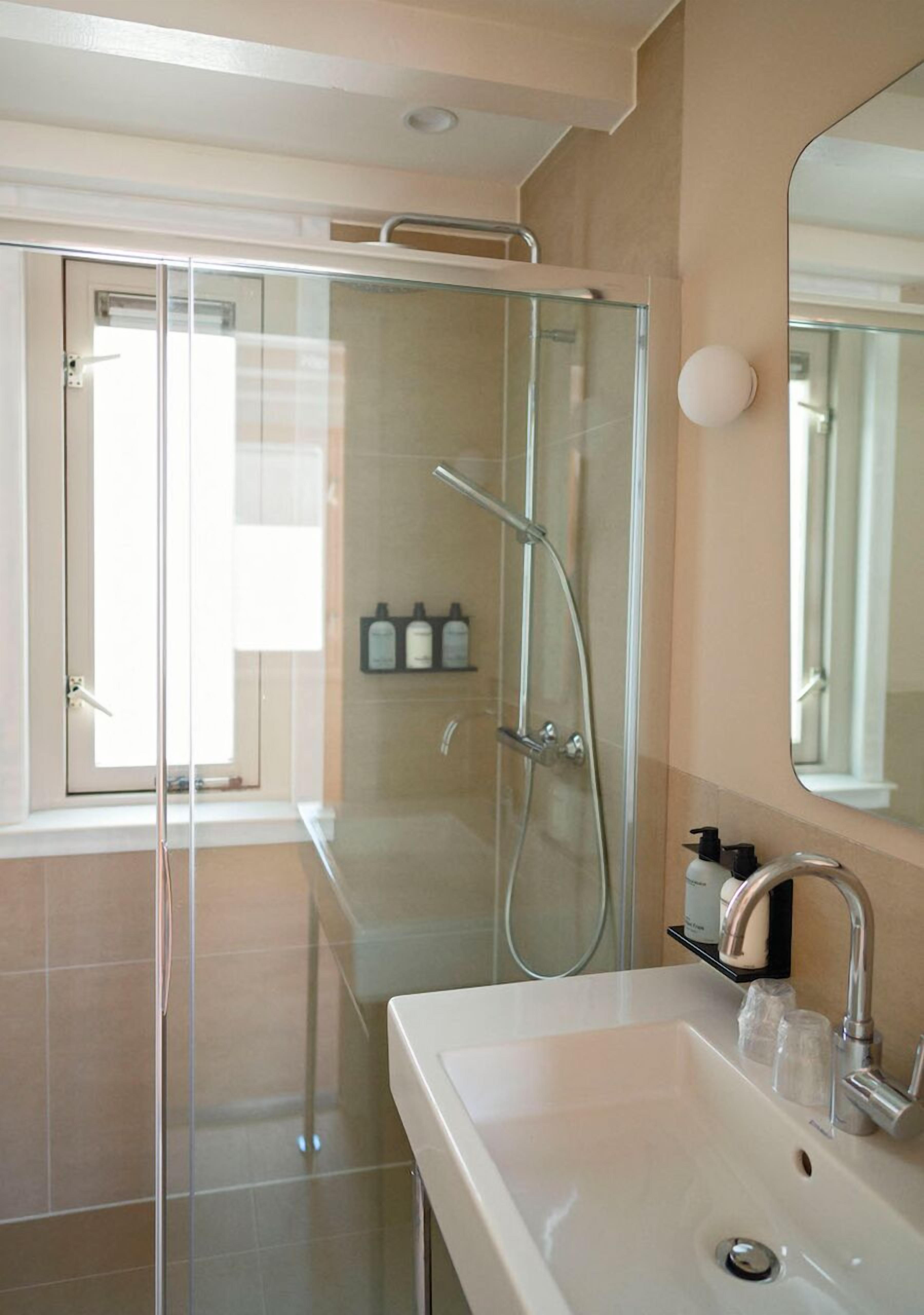 standard twin room | bathroom | designer toiletries, hair dryer, towels, soap