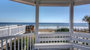 A covered outdoor seating area with a view of the beach and ocean. - Ocean Retreat with Private Beach Access (Kure Beach)