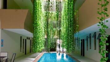 Indoor pool, open 8:00 AM to 9:00 PM, pool loungers