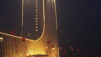 A tall building with vertical lines and a curved facade.