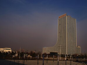 A modern building with vertical lines and a unique design.