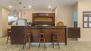 A lobby bar area with a wooden counter, three stools, and overhead lighting. - Gloria Saints Constantine And Helena (Varna)